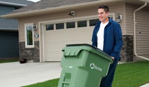 Image of young man taking his curbside collection out