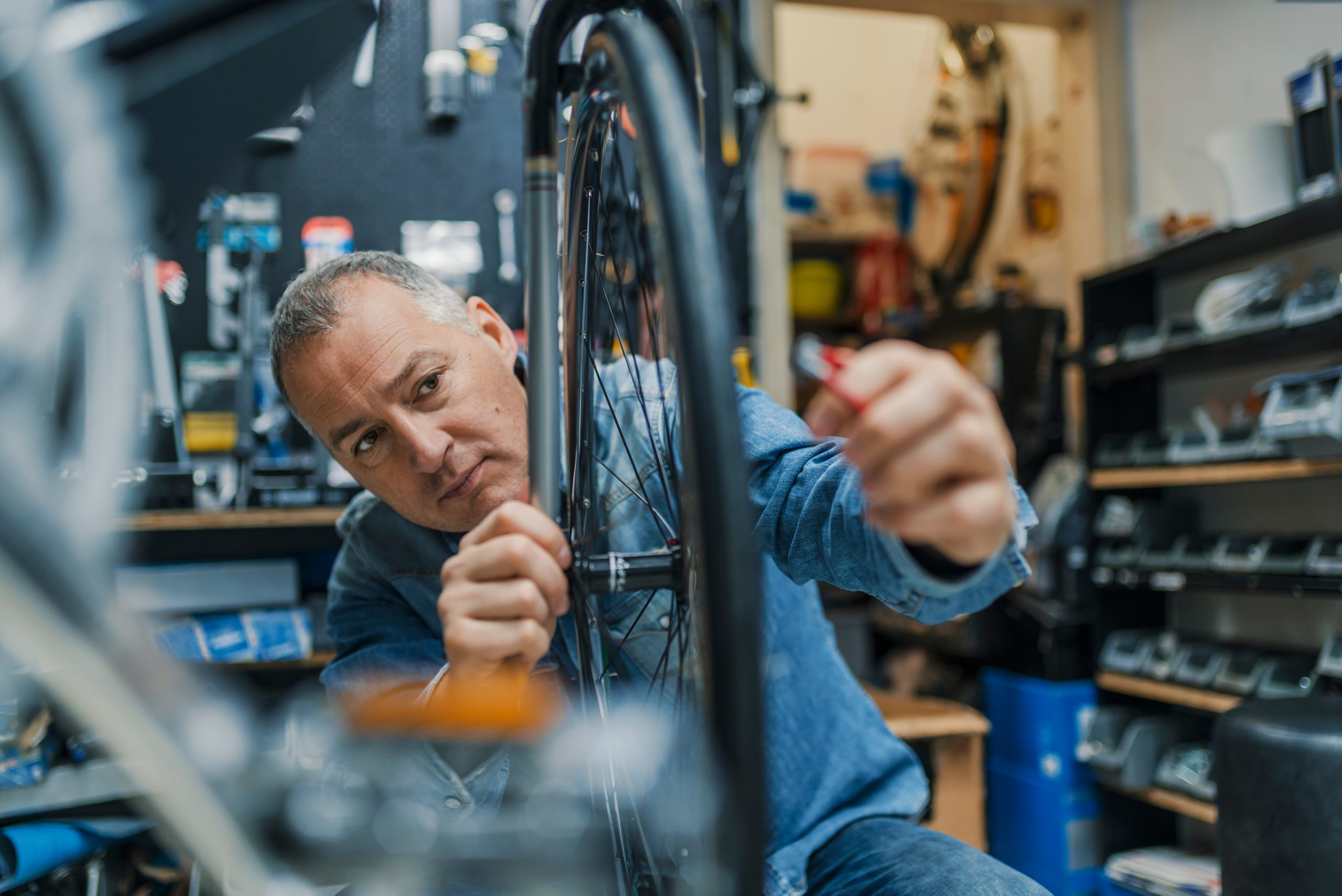 Bicycle mechanic in a workshop repairs a bike