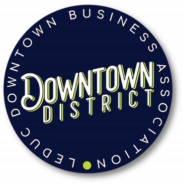 http://Circular%20logo%20reading%20Downtown%20District%20with%20Downtown%20Leduc%20Business%20Association%20around%20the%20edge%20on%20a%20dark%20blue%20background.