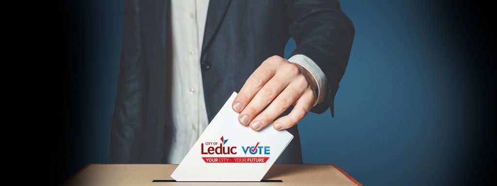 Person in a suit placing a "Leduc Election" ballot into a voting box against a blue background.