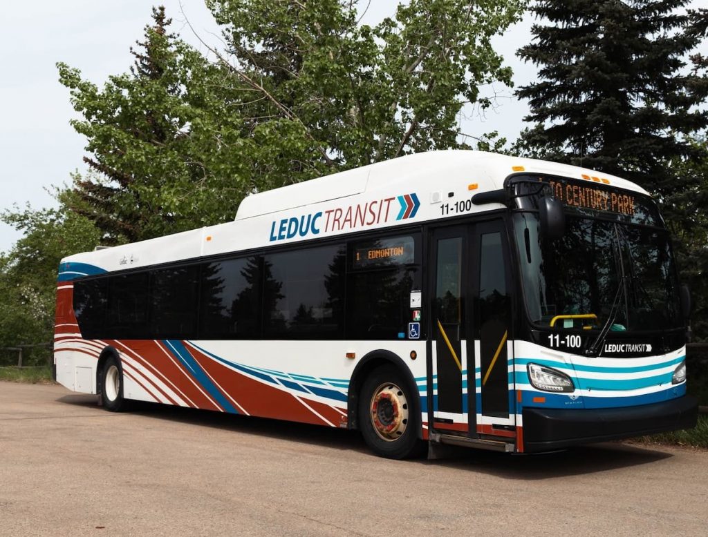 A Leduc Transit bus parked on a road with trees in the background, displaying "To Century Park" on the front.