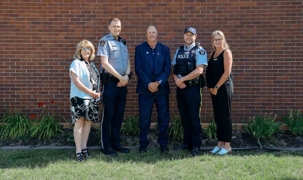 Group photo of five city staff, including the new school resource officer (SRO)