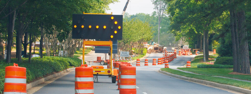Image of City of Leduc road closures, with a sign that says road closed with pilons laid out.