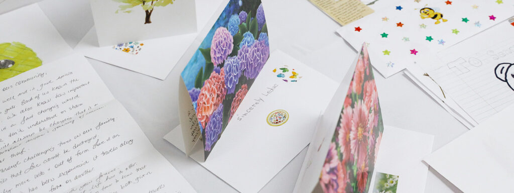 Image of post cards and drawings laid out on a table for the Sincerely, Leduc campaign.